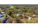A high angle view of a home nestled into mature trees and landscaping showing the surrounding neighborhood at 37350 Neighbors Path, Zephyrhills, FL 33542