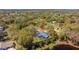 Aerial view of property with a screened-in pool and spacious yard at 37350 Neighbors Path, Zephyrhills, FL 33542