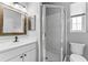 Bathroom features a single vanity, standing shower with glass door, and a toilet at 37350 Neighbors Path, Zephyrhills, FL 33542