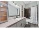 Bathroom featuring a shower/tub combo, cabinets, and a large mirror at 37350 Neighbors Path, Zephyrhills, FL 33542