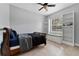 This bedroom features a ceiling fan, natural light, built-in shelves, and a window seat at 37350 Neighbors Path, Zephyrhills, FL 33542