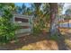 Backyard featuring a chicken coop surrounded by trees and greenery at 37350 Neighbors Path, Zephyrhills, FL 33542