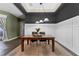 Dining room features modern wainscoting, designer light fixture and a large window at 37350 Neighbors Path, Zephyrhills, FL 33542