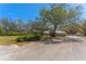 Charming single-story home with mature trees, a long driveway, and a well-maintained front lawn at 37350 Neighbors Path, Zephyrhills, FL 33542