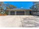 Large two-car garage with an expansive driveway and ample parking space at 37350 Neighbors Path, Zephyrhills, FL 33542