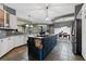 Modern kitchen with white cabinets, stainless appliances and an island with cooktop at 37350 Neighbors Path, Zephyrhills, FL 33542