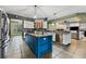 Spacious kitchen features a blue island, modern appliances and opens to the living room at 37350 Neighbors Path, Zephyrhills, FL 33542