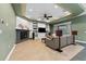 Open living room with fireplace, built-in shelving, and plenty of natural light at 37350 Neighbors Path, Zephyrhills, FL 33542