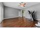 Spacious room featuring hardwood floors, ceiling fan, and ample natural light at 37350 Neighbors Path, Zephyrhills, FL 33542