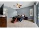 Bedroom featuring a ceiling fan, windows with blinds, and a door leading to the outside at 37350 Neighbors Path, Zephyrhills, FL 33542