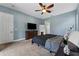 Bedroom featuring a ceiling fan, a flat screen TV, and a large dresser at 37350 Neighbors Path, Zephyrhills, FL 33542