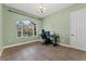 Comfortable office space with a large window, chandelier, and neutral paint at 37350 Neighbors Path, Zephyrhills, FL 33542