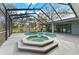 Screened in pool and spa with exterior access and a lovely view of the lush backyard at 37350 Neighbors Path, Zephyrhills, FL 33542