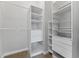 A closet features a section for hanging clothes, built in shelves, and built in drawers at 37350 Neighbors Path, Zephyrhills, FL 33542