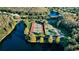 An aerial view of tennis and basketball courts near a lake, enhancing community appeal and outdoor recreation at 3798 Darston St, Palm Harbor, FL 34685
