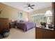 Bright primary bedroom with plush carpet, ample natural light, a purple bedspread, and neutral walls at 3798 Darston St, Palm Harbor, FL 34685