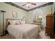 Serene bedroom featuring a floral accent wall, large window, and natural light, complemented by a comfortable bed at 3798 Darston St, Palm Harbor, FL 34685