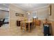 Elegant dining room featuring travertine tile flooring, a modern chandelier, and neutral paint at 3798 Darston St, Palm Harbor, FL 34685
