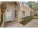 Front entrance of a home featuring a glass door and beautiful, well maintained landscaping at 3798 Darston St, Palm Harbor, FL 34685