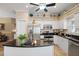 Cozy eat-in kitchen featuring white cabinets, granite countertops, stainless steel appliances, and tile flooring at 3798 Darston St, Palm Harbor, FL 34685