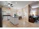 Charming eat-in kitchen with black countertops, white cabinets, an island, and a connected dining area at 3798 Darston St, Palm Harbor, FL 34685