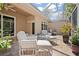 Enclosed patio featuring comfortable white chairs and potted plants creating a tranquil atmosphere at 3798 Darston St, Palm Harbor, FL 34685