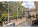 Relaxing screened patio with tile floor, comfortable seating, and lush greenery surrounding the area at 3798 Darston St, Palm Harbor, FL 34685