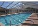 Enclosed in-ground swimming pool with a screened enclosure and brick paver deck at 3798 Darston St, Palm Harbor, FL 34685