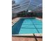 Screened in-ground swimming pool with brick paver deck at 3798 Darston St, Palm Harbor, FL 34685