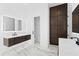 Bright bathroom features a marble floor, floating vanity, and dark wood storage cabinets at 4308 W Beach Park Dr, Tampa, FL 33609