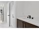 Modern bathroom vanity features marble countertops, dark wood cabinetry, and matte black hardware at 4308 W Beach Park Dr, Tampa, FL 33609