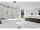 Stunning bathroom with a freestanding tub, sleek fixtures, marble accents, and a walk-in shower for a spa-like experience at 4308 W Beach Park Dr, Tampa, FL 33609