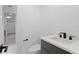 Sleek bathroom features a modern vanity with marble countertops, dark wood cabinetry, and matte black hardware at 4308 W Beach Park Dr, Tampa, FL 33609