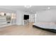 Open bedroom with custom built-in shelves, a television, and outside access at 4308 W Beach Park Dr, Tampa, FL 33609