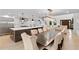 Open-concept dining room and living room with modern chandelier and stylish decor and views to the kitchen at 4308 W Beach Park Dr, Tampa, FL 33609