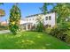 Charming two-story home with lush landscaping, well-manicured lawn, and private driveway at 4308 W Beach Park Dr, Tampa, FL 33609