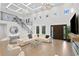 Beautiful living room with soaring ceilings, modern chandeliers, and ample natural light at 4308 W Beach Park Dr, Tampa, FL 33609
