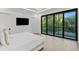 This main bedroom boasts sliding glass doors to a balcony and features a wall-mounted television at 4308 W Beach Park Dr, Tampa, FL 33609