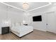 Serene bedroom featuring a modern chandelier, neutral tones, and ample natural light for relaxation at 4308 W Beach Park Dr, Tampa, FL 33609