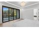 Luxurious bedroom features a modern chandelier, large windows offering beautiful views and plenty of natural light at 4308 W Beach Park Dr, Tampa, FL 33609