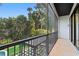 Screened patio with railing overlooks lush landscaping and a portion of a pool at 4308 W Beach Park Dr, Tampa, FL 33609