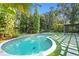 Inviting pool area surrounded by tropical greenery and a stylish pergola at 4308 W Beach Park Dr, Tampa, FL 33609
