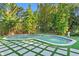 Lush backyard oasis featuring a freeform pool with modern tile surround at 4308 W Beach Park Dr, Tampa, FL 33609