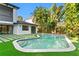Inviting pool with stylish tile border and lush landscaping creates a serene backyard retreat at 4308 W Beach Park Dr, Tampa, FL 33609