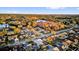 Aerial view of residential neighborhood near a lake surrounded by lush green trees at 4823 Deer Lodge Rd, New Port Richey, FL 34655