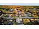 Aerial view of neighborhood homes near a tree-lined lake under a clear blue sky at 4823 Deer Lodge Rd, New Port Richey, FL 34655
