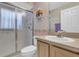 Cozy bathroom featuring a shower with glass doors, and wallpaper at 4823 Deer Lodge Rd, New Port Richey, FL 34655