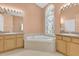 Bathroom showcasing a soaking tub and a unique stained-glass window feature at 4823 Deer Lodge Rd, New Port Richey, FL 34655