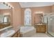 Bright bathroom with a garden tub, stained glass window, and a separate shower at 4823 Deer Lodge Rd, New Port Richey, FL 34655