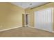 Bedroom featuring carpet, a closet, and an open doorway to the Primary bath at 4823 Deer Lodge Rd, New Port Richey, FL 34655